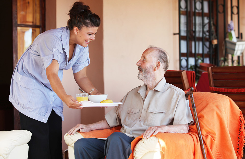 Carer handing a resident food