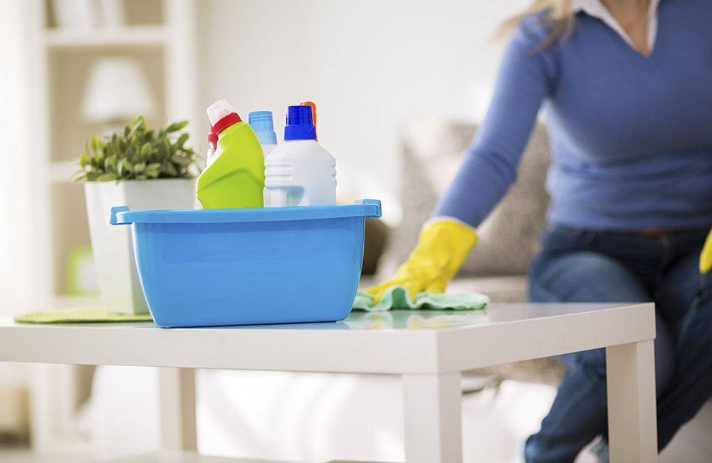 Someone cleaning a kitchen side