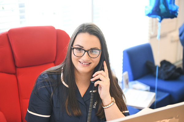 Hands on Care employee on the phone looking into the distance