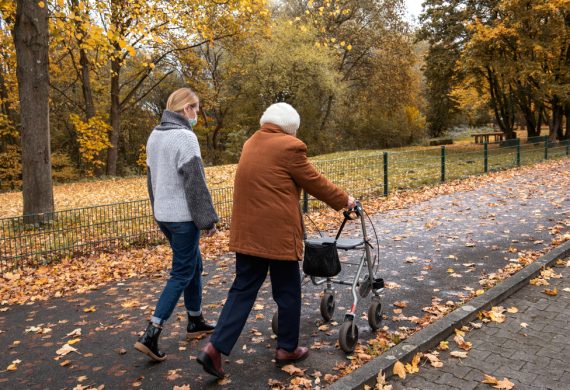 Caregiver and resident going for a walk on an Autumn day