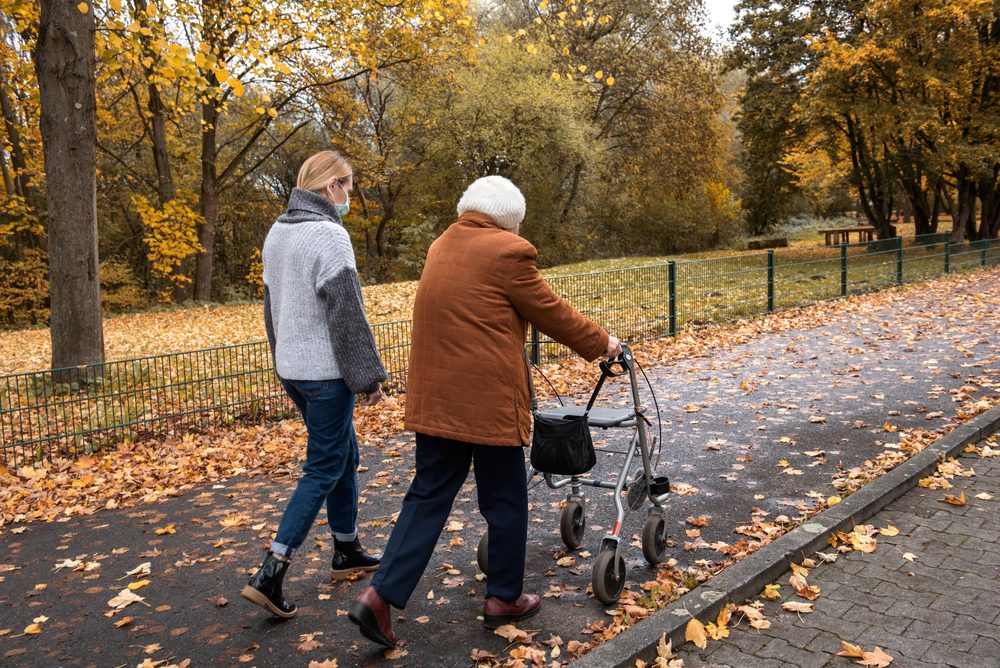 Caregiver and resident going for a walk on an Autumn day