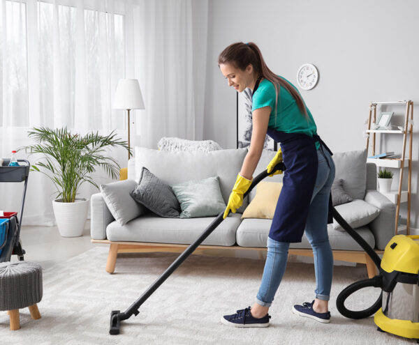 Hands On Care carrying out professional cleaning and hoovering as part of a home cleaning service.
